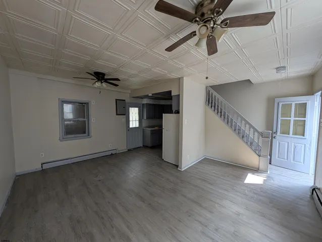 a kitchen with a refrigerator a sink and cabinets
