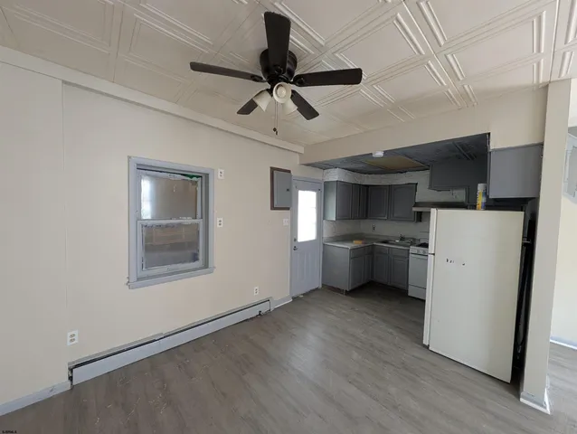 a kitchen with a refrigerator sink and cabinets