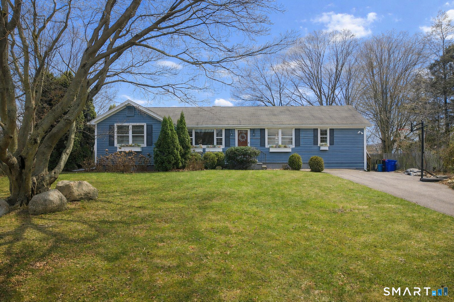 19 Lyncrest Drive Norwalk, CT 06851 - Photo 2 of 41 a front view of a house with a yard and trees