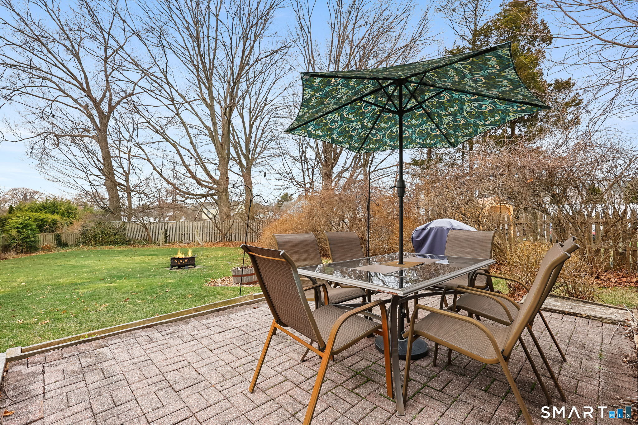 19 Lyncrest Drive Norwalk, CT 06851 - Photo 37 of 41 a view of a backyard with table and chairs under an umbrella