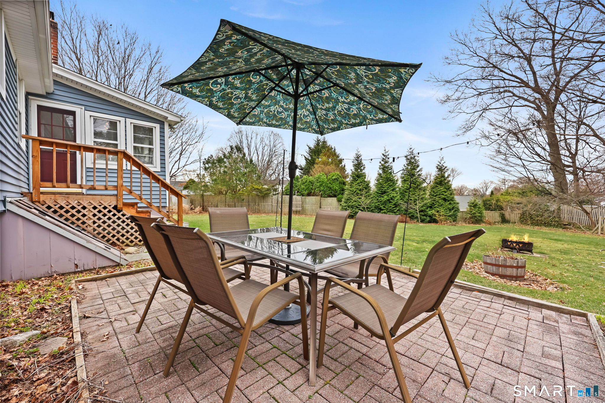 19 Lyncrest Drive Norwalk, CT 06851 - Photo 38 of 41 a view of a roof deck with table and chairs under an umbrella with wooden floor and fence