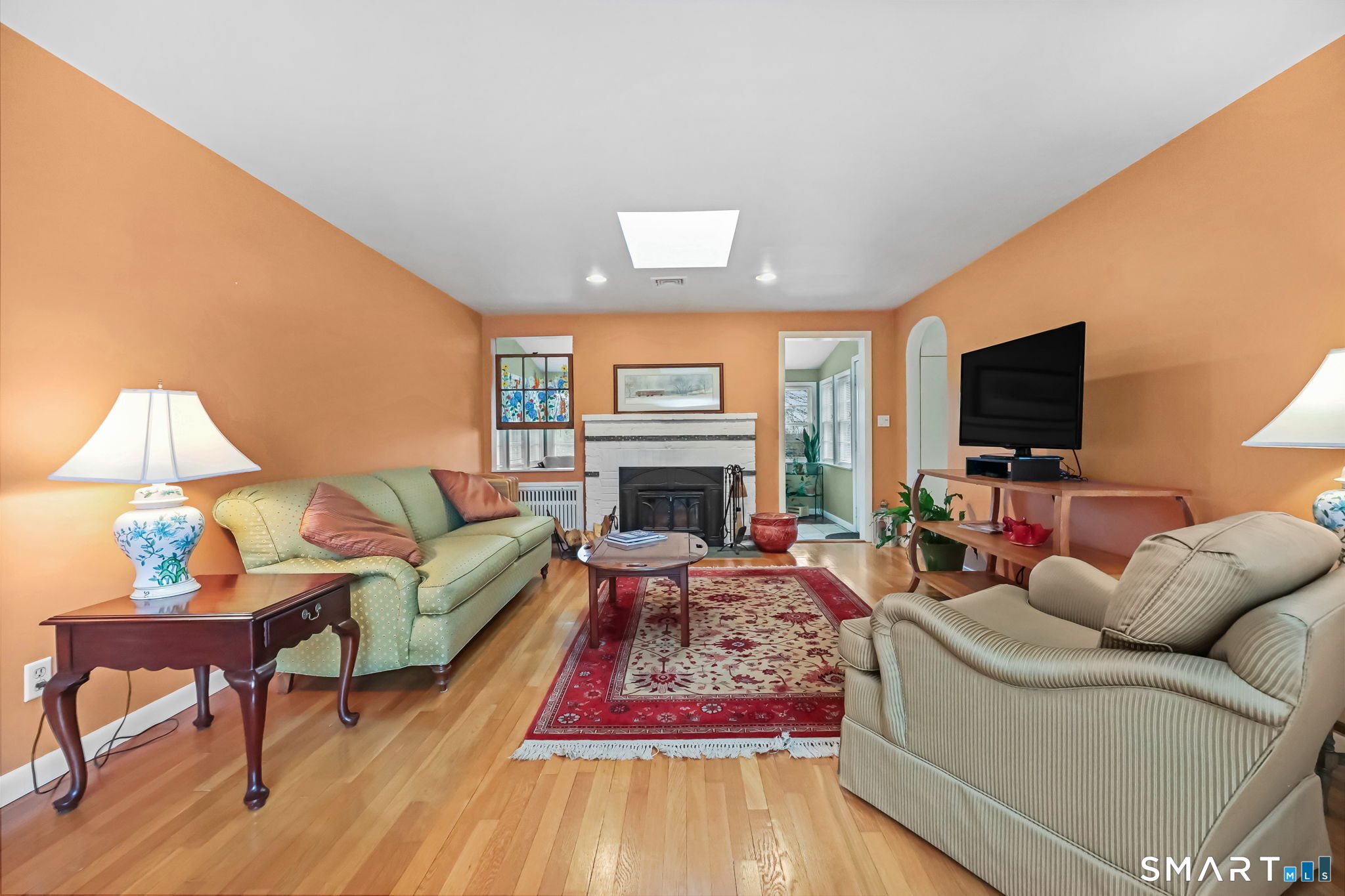 19 Lyncrest Drive Norwalk, CT 06851 - Photo 7 of 41 a living room with furniture a flat screen tv and a fireplace