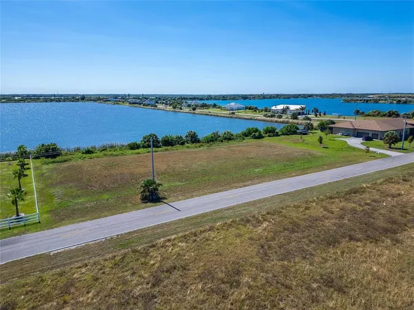 a view of a lake with houses in the back