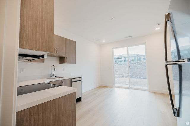 2759 Becco Trail, Unit 16 St. George, UT 84770 - Photo 31 of 42 Kitchen with modern cabinets, appliances with stainless steel finishes, recessed lighting, light wood finished floors, and brown cabinetry