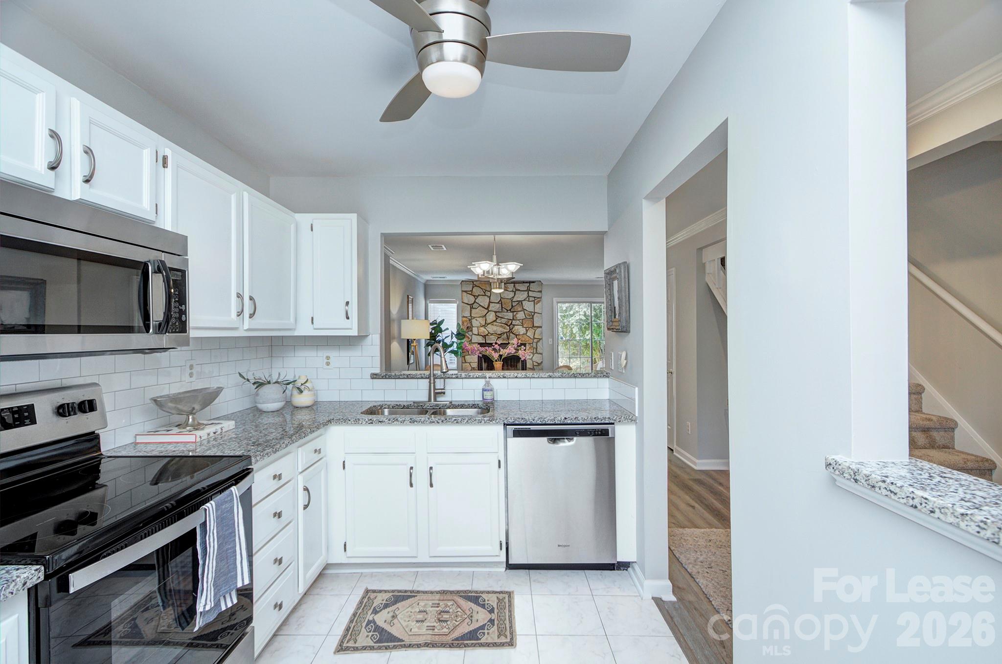 8268 Golf Ridge Drive Charlotte, NC 28277 - Photo 7 of 24 a kitchen with a sink stove and microwave