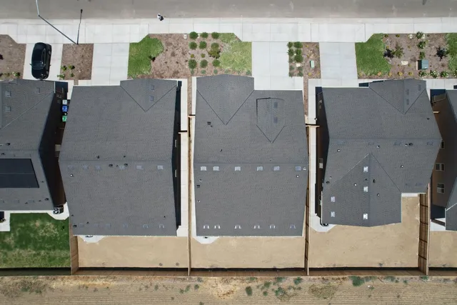 an aerial view of a house with a yard