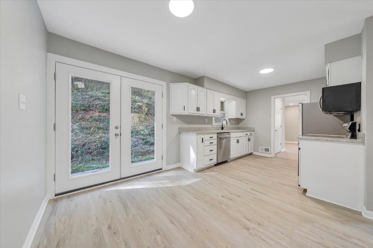 8633 Grassy Hill Road Boones Mill, VA 24065 - Photo 12 of 33 a view of kitchen with wooden floor electronic appliances and window