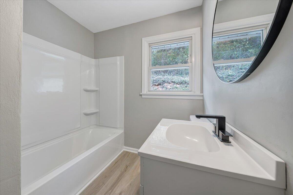 8633 Grassy Hill Road Boones Mill, VA 24065 - Photo 19 of 33 a bathroom with a sink a bathtub and a window