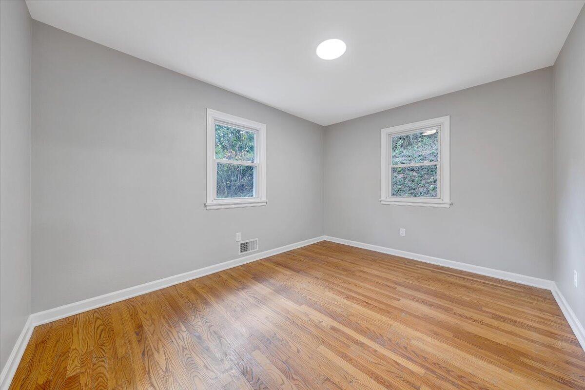 8633 Grassy Hill Road Boones Mill, VA 24065 - Photo 22 of 33 a view of empty room with wooden floor and fan