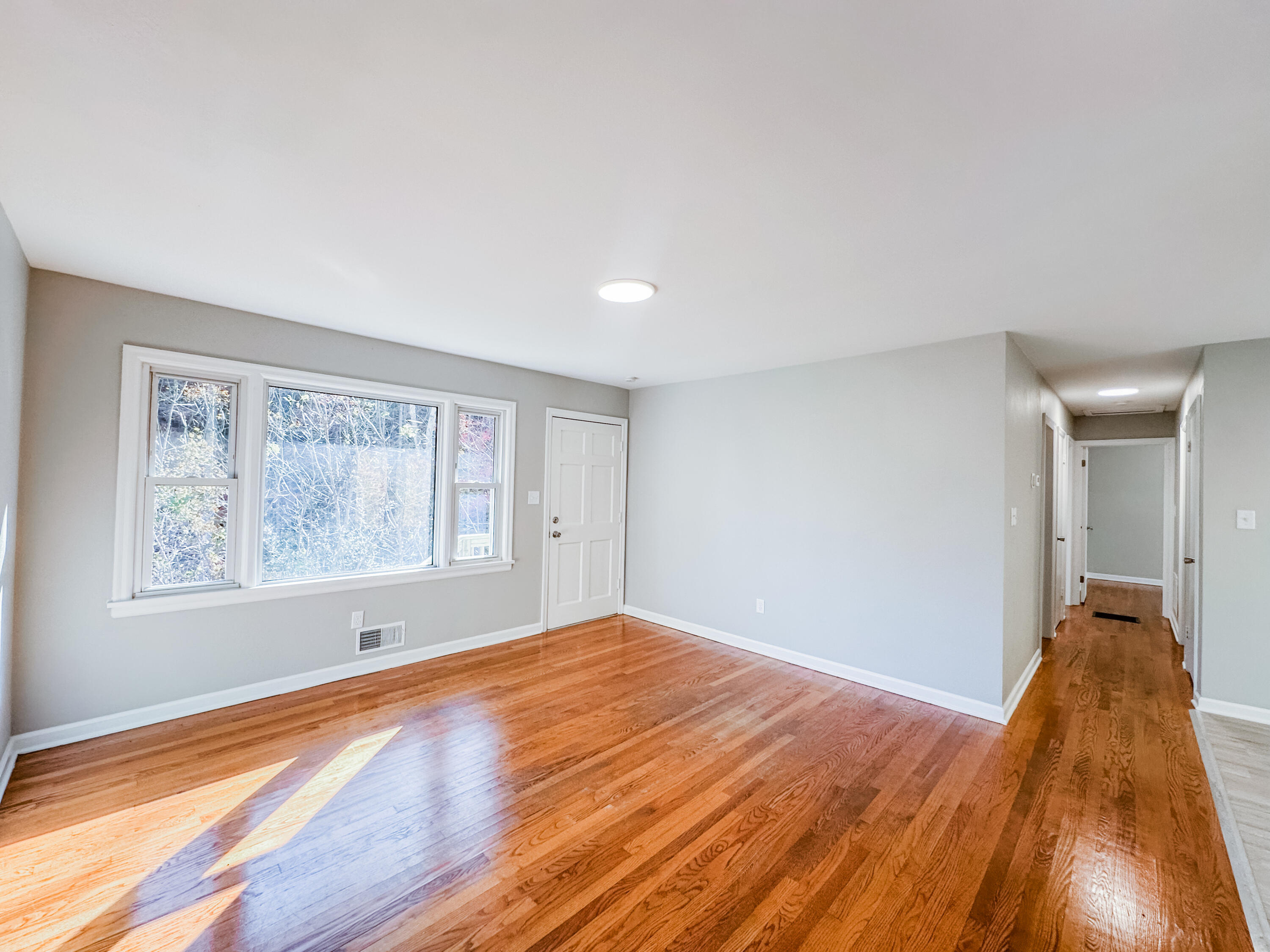 8633 Grassy Hill Road Boones Mill, VA 24065 - Photo 4 of 33 a view of a big room with wooden floor and windows