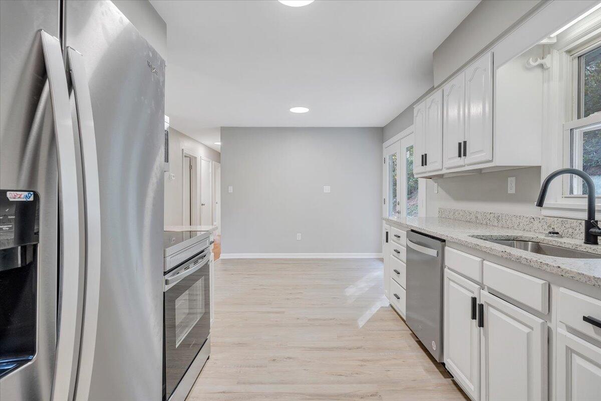 8633 Grassy Hill Road Boones Mill, VA 24065 - Photo 5 of 33 a kitchen with stainless steel appliances granite countertop a refrigerator and a sink