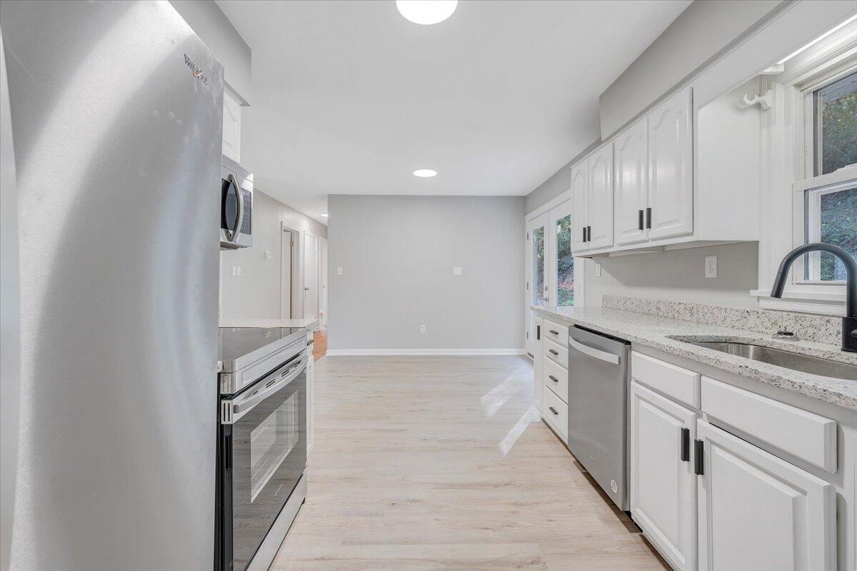 8633 Grassy Hill Road Boones Mill, VA 24065 - Photo 6 of 33 a kitchen with white cabinets and sink
