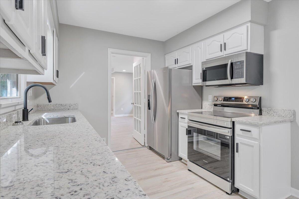 8633 Grassy Hill Road Boones Mill, VA 24065 - Photo 8 of 33 a kitchen with stainless steel appliances granite countertop a stove a microwave and a sink