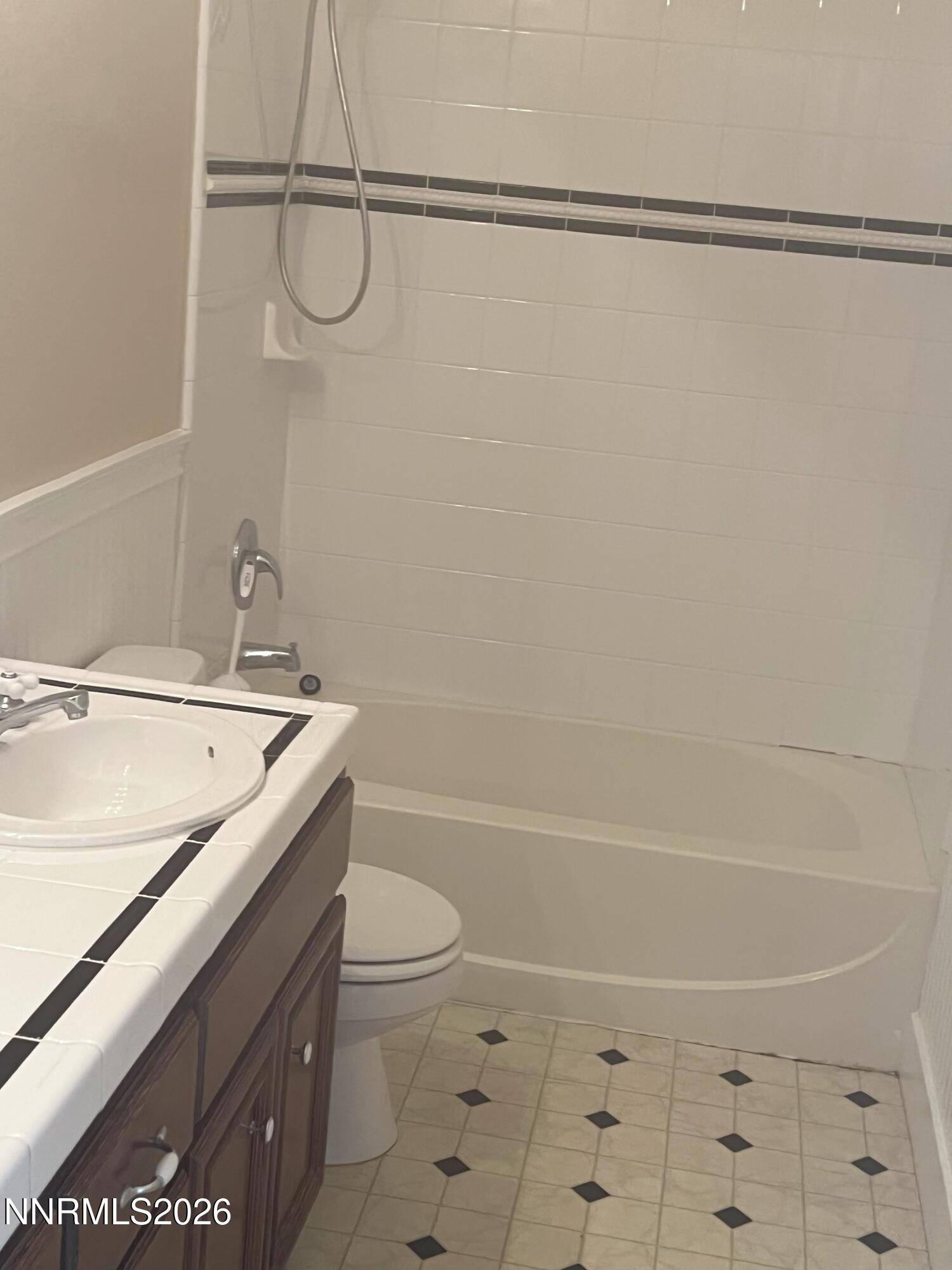 1010 10th Street, Unit B Sparks, NV 89431 - Photo 2 of 4 a bathroom with a granite countertop bathtub shower sink vanity and toilet