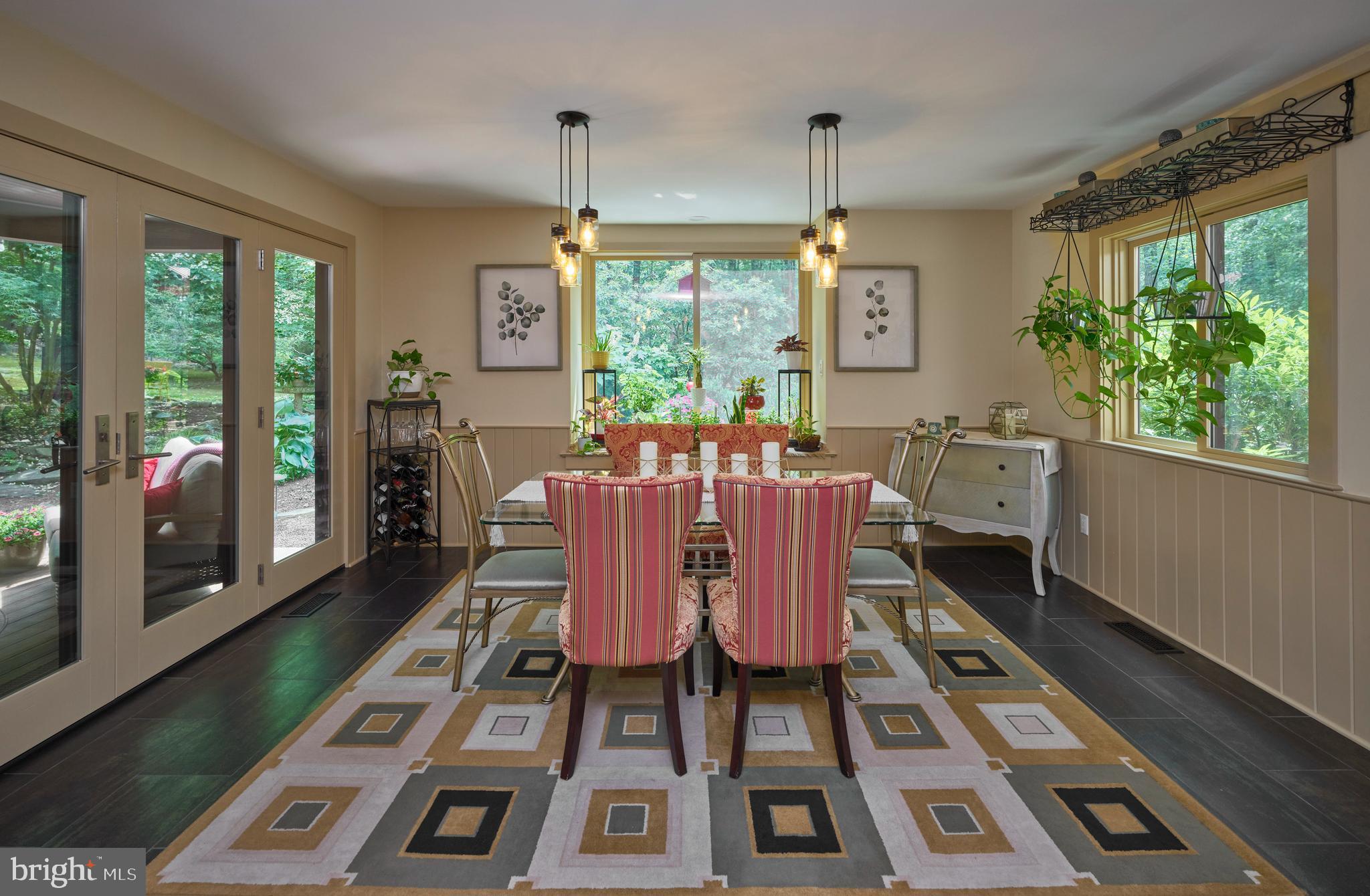 7028 Ely Road New Hope, PA 18938 - Photo 12 of 65 a dining room with furniture a chandelier and wooden floor