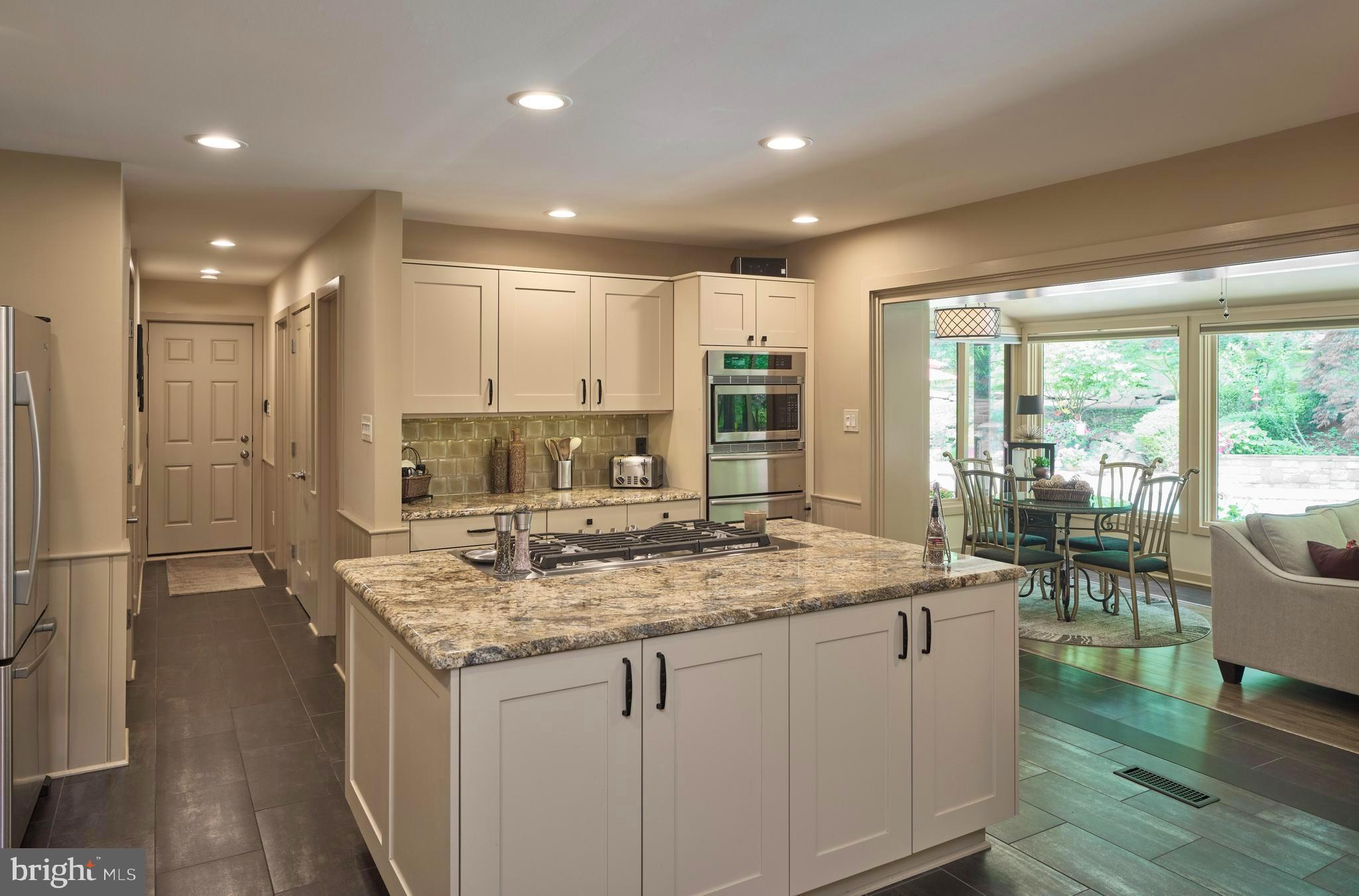 7028 Ely Road New Hope, PA 18938 - Photo 14 of 65 a kitchen with kitchen island granite countertop a sink and a stove
