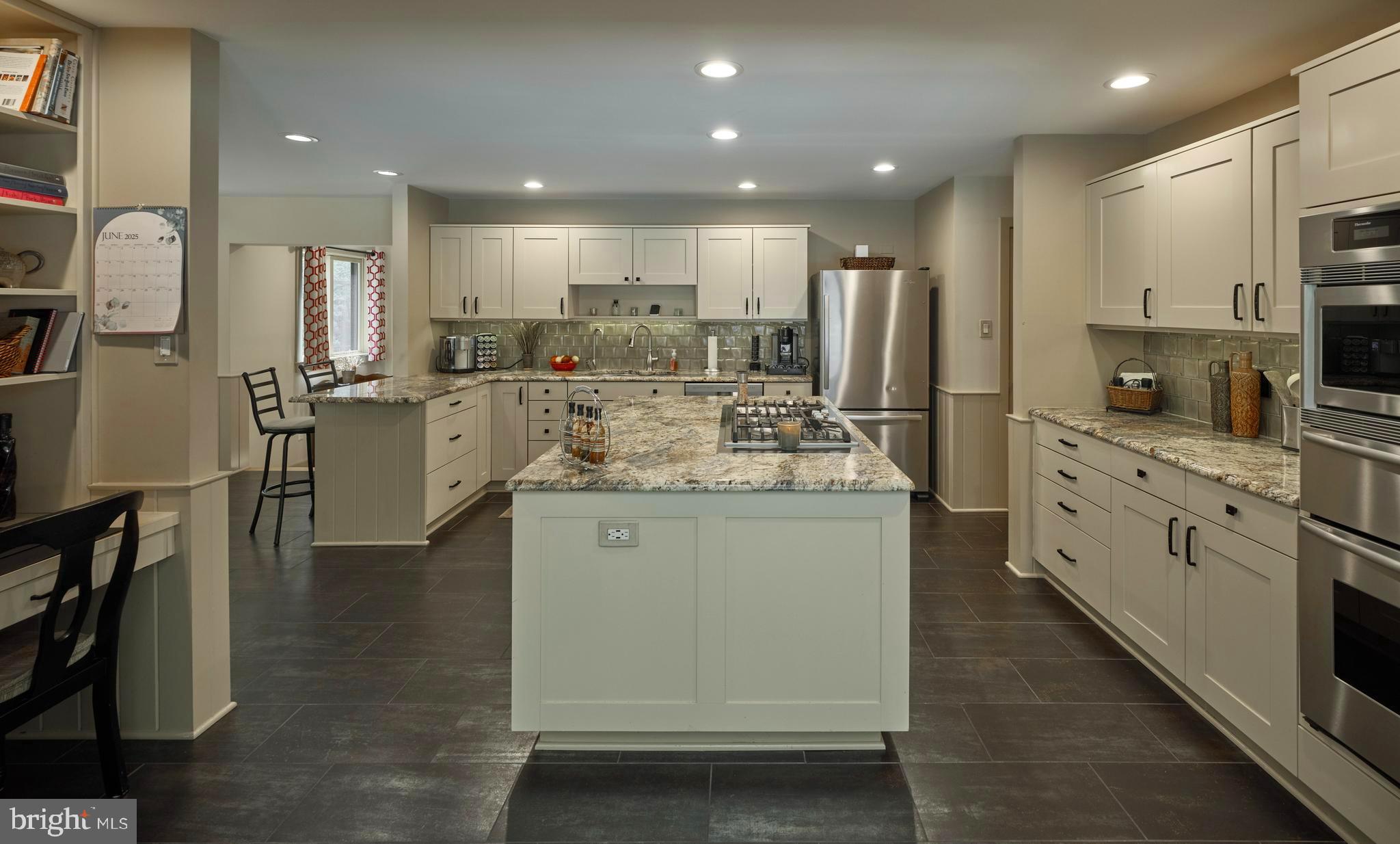 7028 Ely Road New Hope, PA 18938 - Photo 15 of 65 a kitchen with stainless steel appliances kitchen island granite countertop a refrigerator a stove a sink dishwasher and a oven with wooden floor