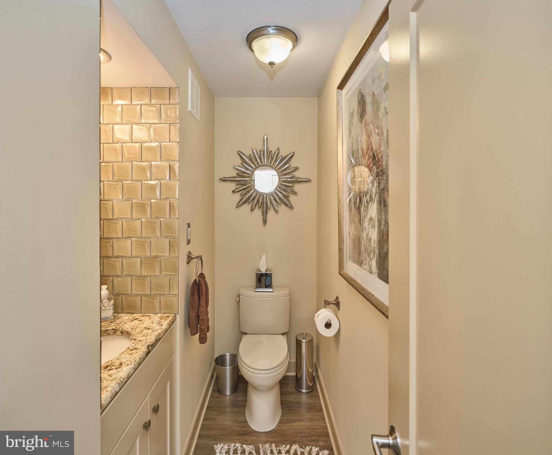 7028 Ely Road New Hope, PA 18938 - Photo 20 of 65 a bathroom with a toilet sink and mirror