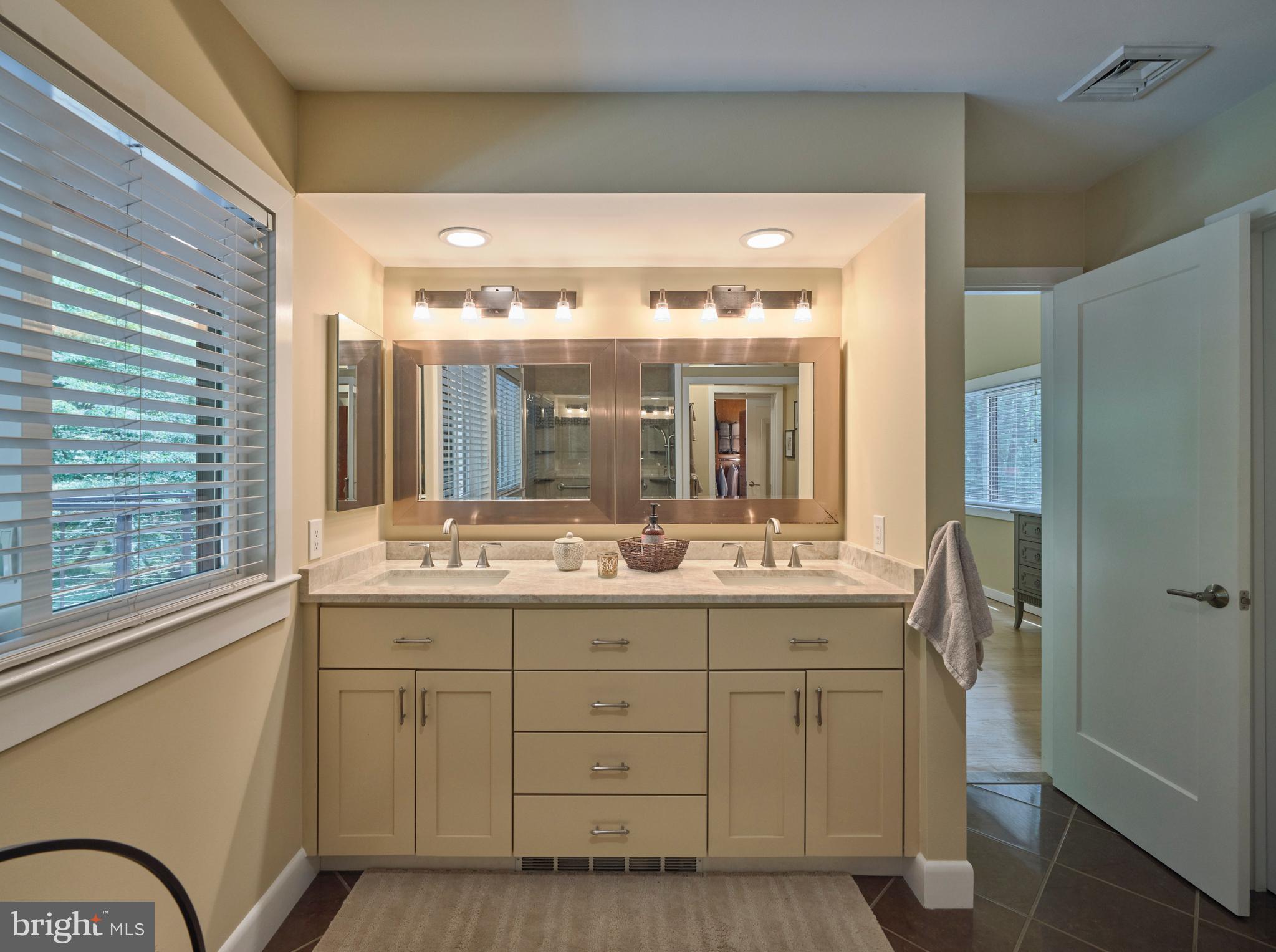 7028 Ely Road New Hope, PA 18938 - Photo 30 of 65 a bathroom with a double vanity sink and mirror with shower