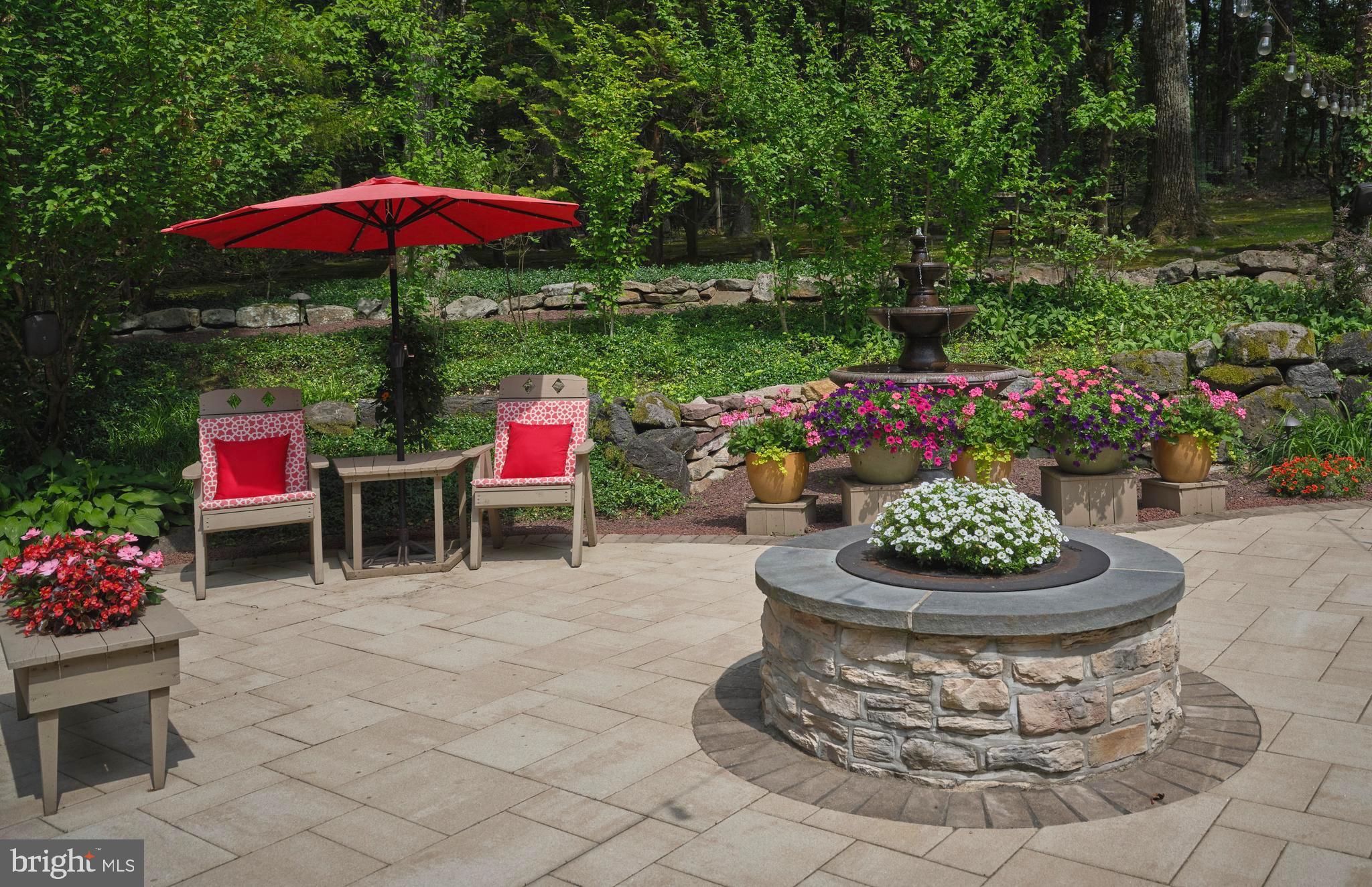 7028 Ely Road New Hope, PA 18938 - Photo 44 of 65 a view of a chairs and table under an umbrella in backyard