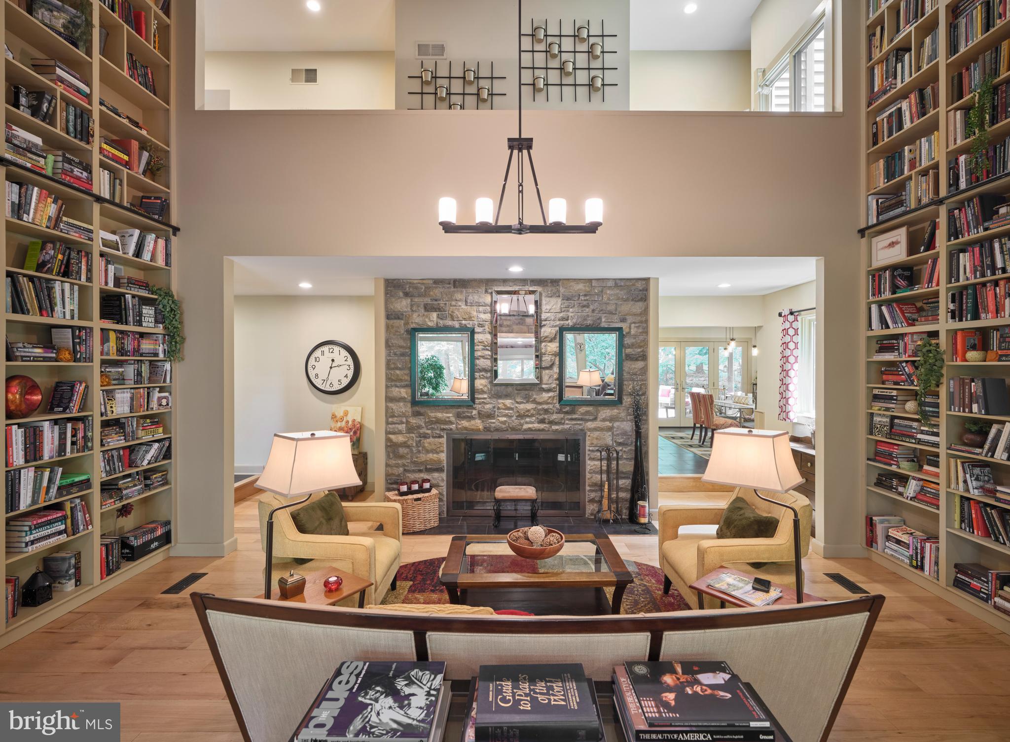 7028 Ely Road New Hope, PA 18938 - Photo 10 of 65 a living room with furniture a fireplace and a chandelier