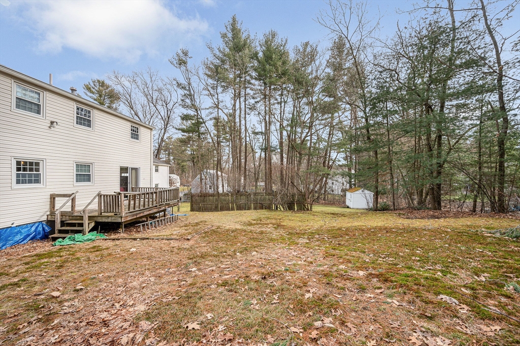 9 Harvard Road Billerica, MA 01821 - Photo 25 of 27 a backyard of a house with barbeque oven and outdoor seating