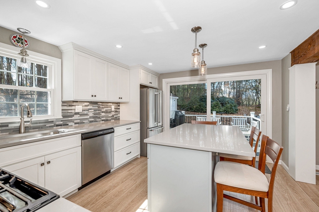 9 Harvard Road Billerica, MA 01821 - Photo 6 of 27 a kitchen with stainless steel appliances granite countertop a stove a sink dishwasher a stove and a refrigerator with wooden floor
