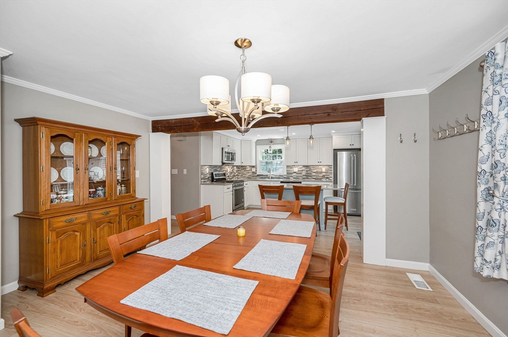 9 Harvard Road Billerica, MA 01821 - Photo 8 of 27 a room with stainless steel appliances kitchen island granite countertop furniture and a chandelier