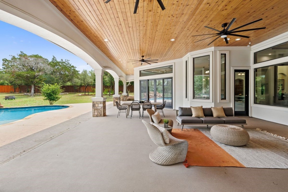 a living room with patio furniture and a floor to ceiling window