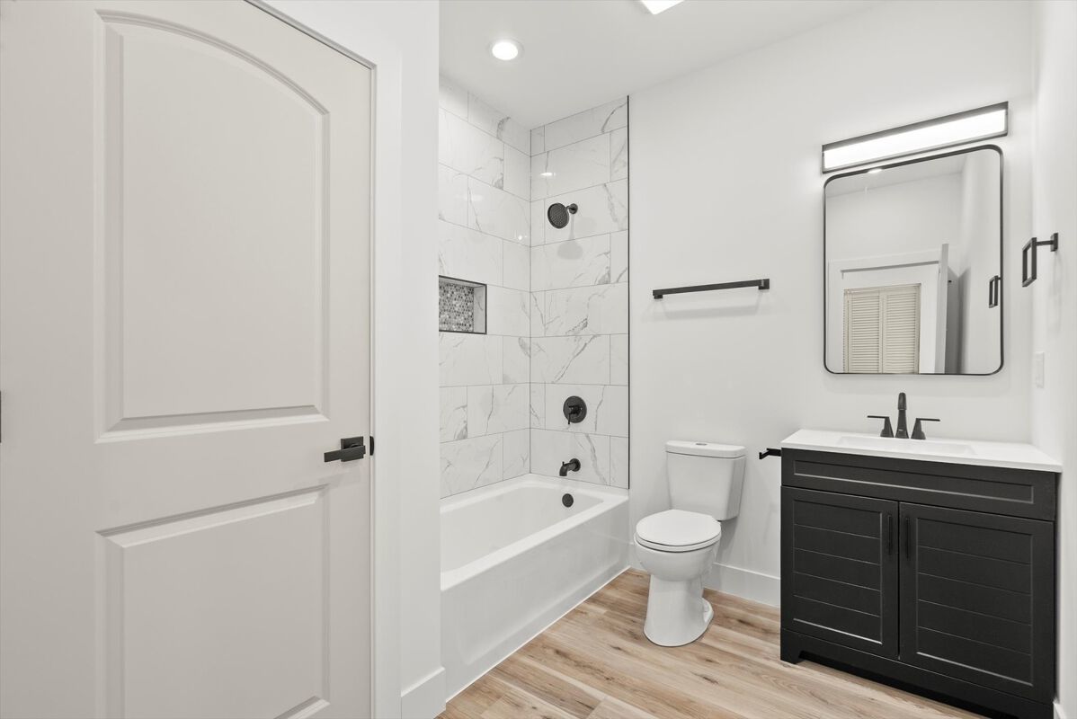 6538 South Rhodes Avenue, Unit 2 Chicago, IL 60637 - Photo 3 of 6 a bathroom with a toilet a sink a mirror a bathtub and vanity