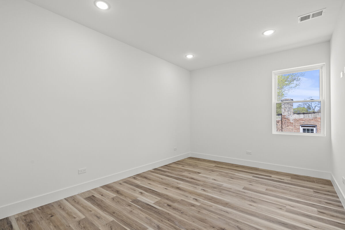 6538 South Rhodes Avenue, Unit 2 Chicago, IL 60637 - Photo 5 of 6 a view of room with window and wooden floor
