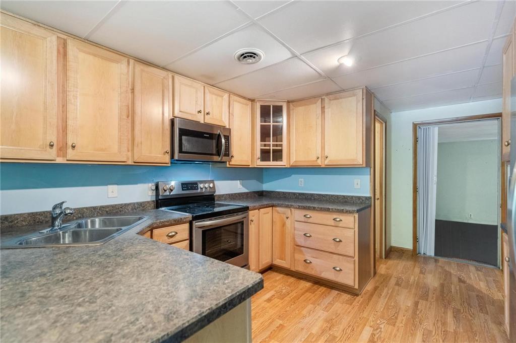 234 Sky Top Road Acme, PA 15610 - Photo 5 of 19 a kitchen with stainless steel appliances granite countertop a stove a sink and a microwave
