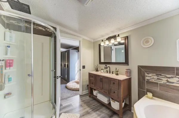 a bathroom with a double vanity sink mirror and shower