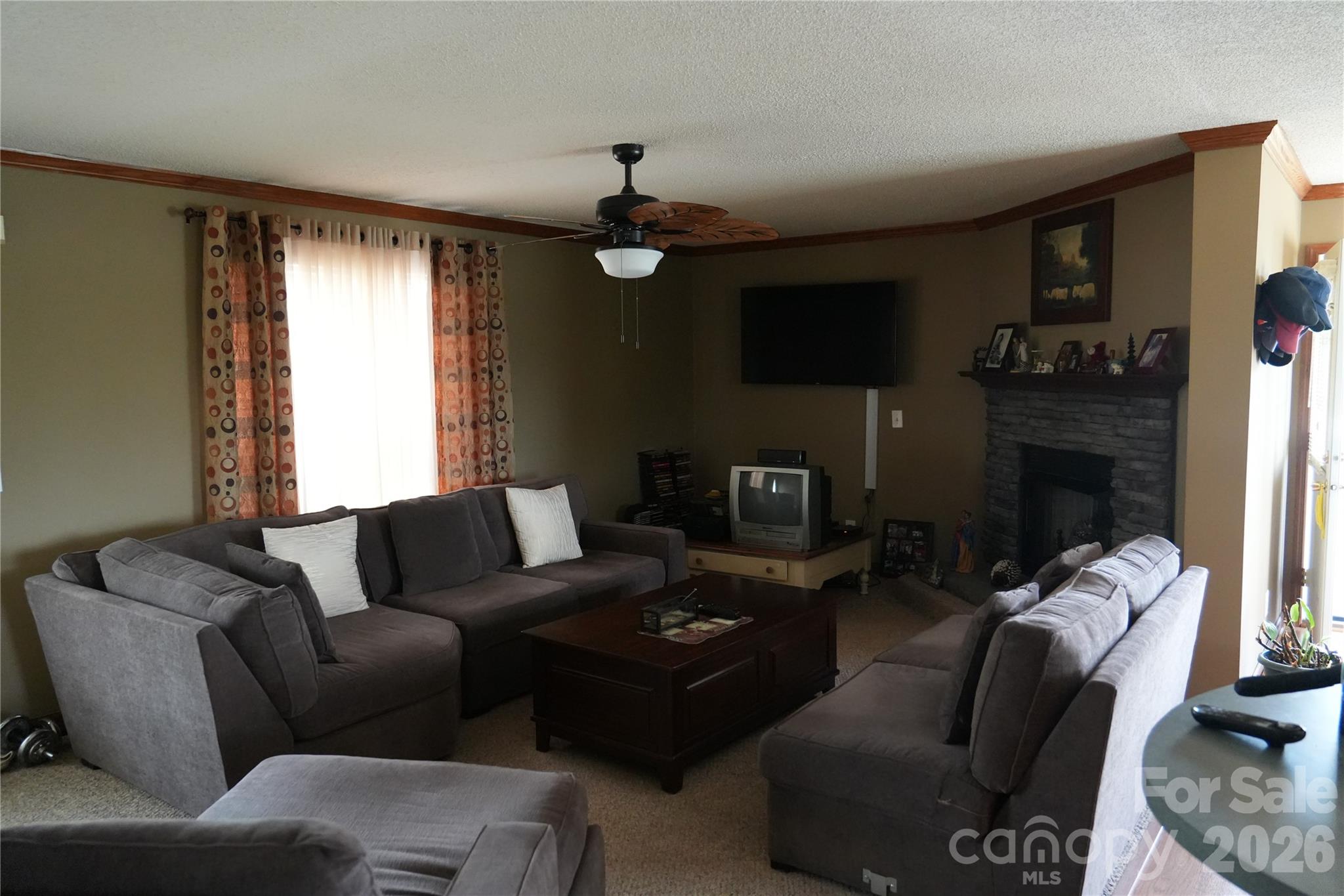 424 Press Walters Road Hartsville, SC 29550 - Photo 6 of 10 a living room with furniture a fireplace and a flat screen tv