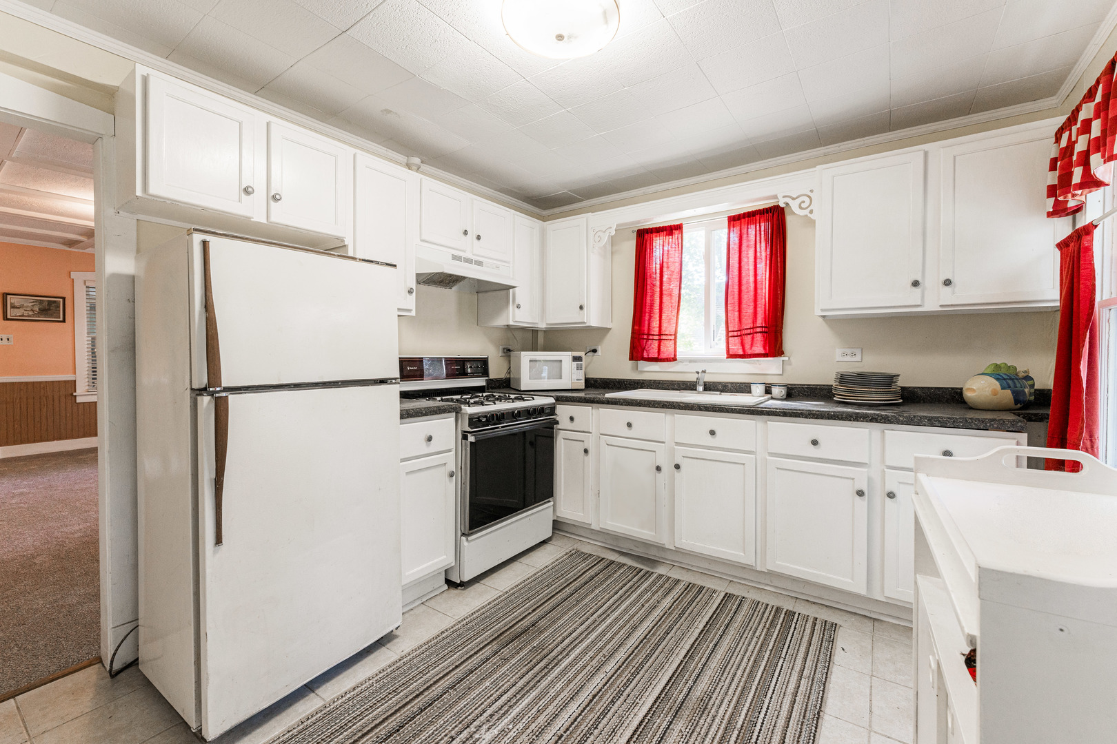 8415 Balder Drive Cary, IL 60013 - Photo 21 of 34 a kitchen with granite countertop white cabinets and white appliances