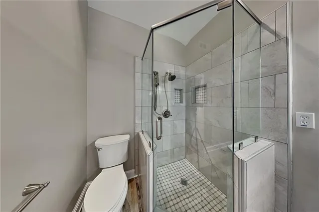 a bathroom with a toilet and a shower