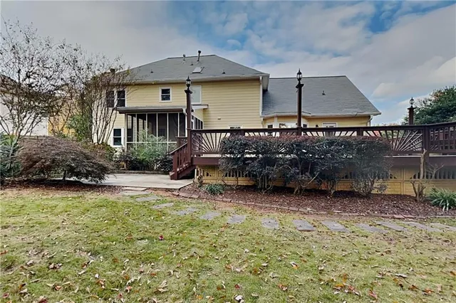a view of a house with a yard balcony and sitting area