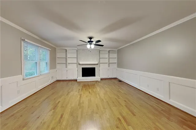 wooden floor in an empty room with a fireplace