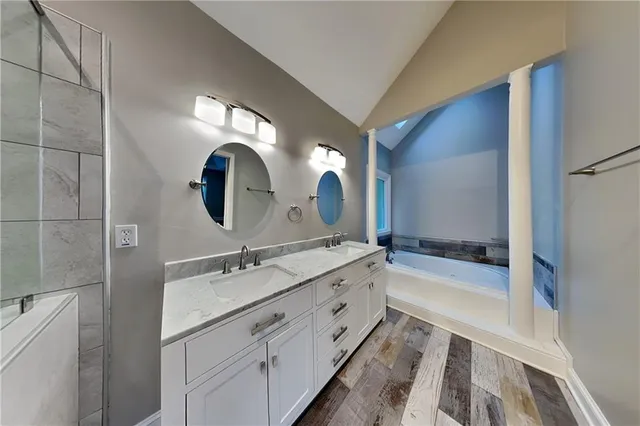 a bathroom with a double vanity sink and a mirror