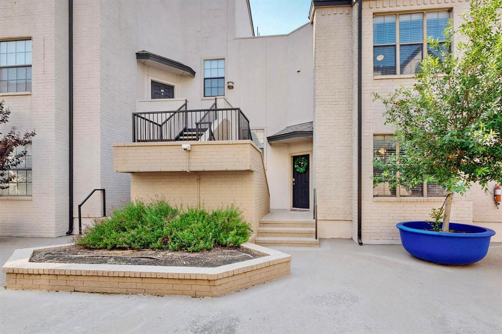 3901 Travis Street, Unit 113 Dallas, TX 75204 - Photo 2 of 40 a front view of a house with a garden