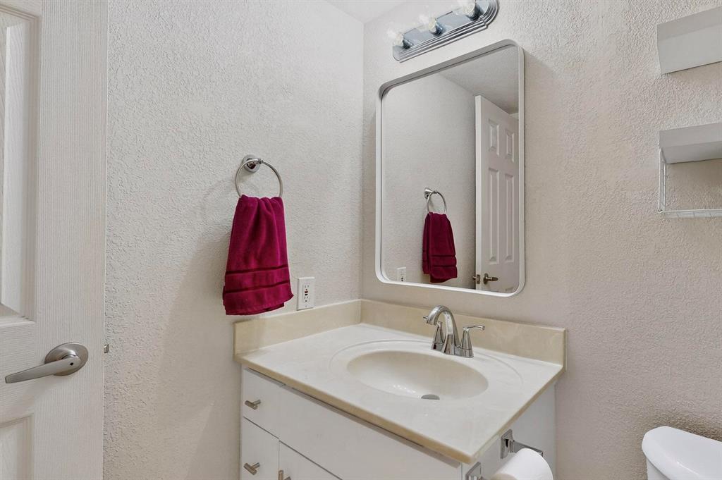 3901 Travis Street, Unit 113 Dallas, TX 75204 - Photo 23 of 40 a bathroom with a sink vanity and mirror