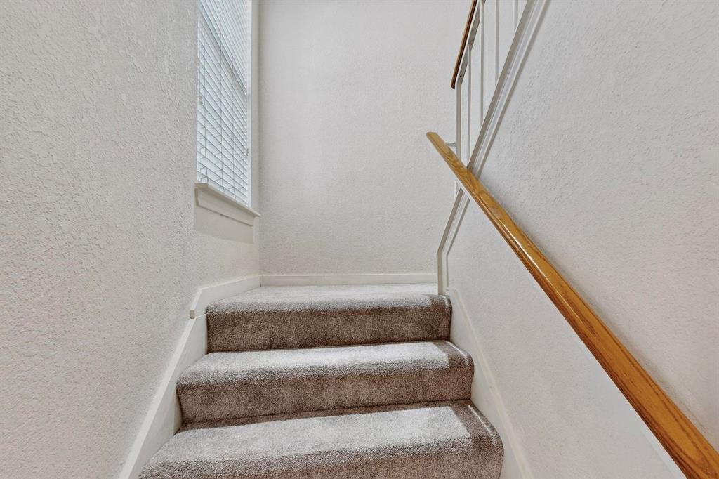 3901 Travis Street, Unit 113 Dallas, TX 75204 - Photo 24 of 40 a view of staircase with white walls and a window