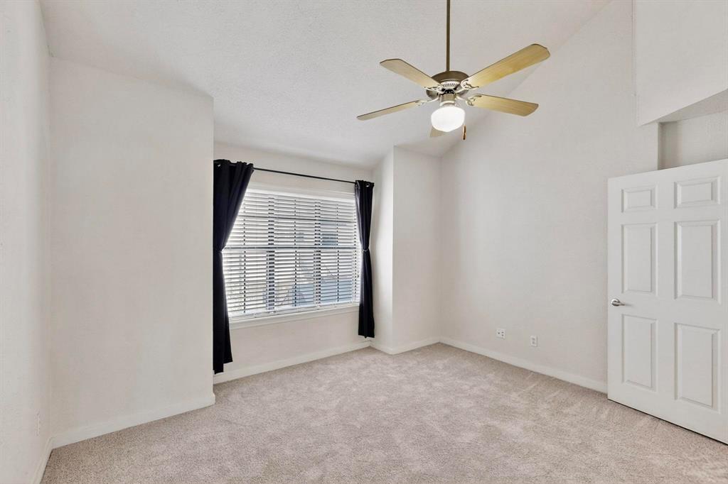 3901 Travis Street, Unit 113 Dallas, TX 75204 - Photo 25 of 40 an empty room with fan and windows