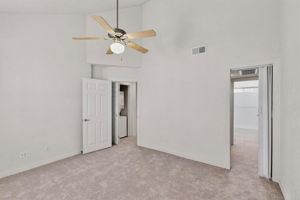 3901 Travis Street, Unit 113 Dallas, TX 75204 - Photo 26 of 40 an empty room with fan and windows