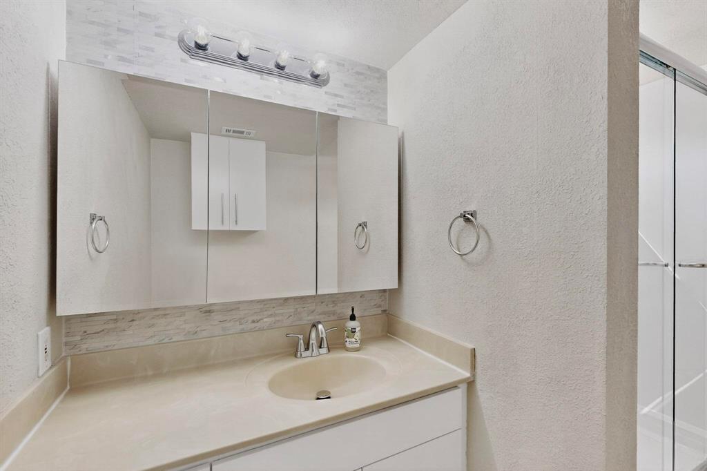 3901 Travis Street, Unit 113 Dallas, TX 75204 - Photo 27 of 40 a bathroom with a sink and a mirror