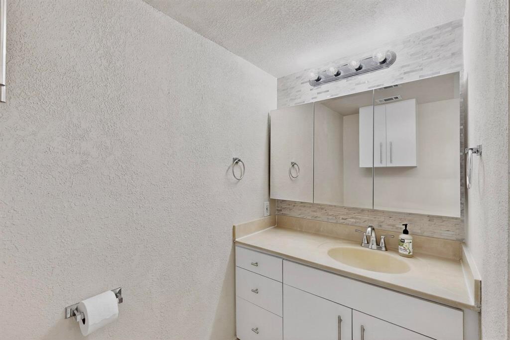 3901 Travis Street, Unit 113 Dallas, TX 75204 - Photo 29 of 40 a bathroom with a sink and a mirror
