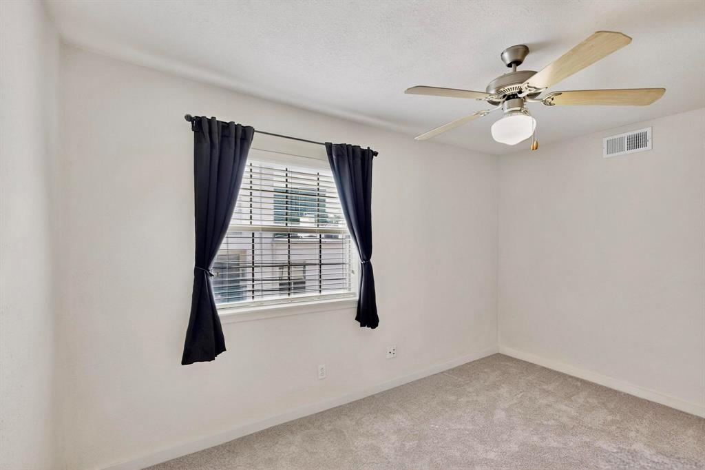 3901 Travis Street, Unit 113 Dallas, TX 75204 - Photo 33 of 40 an empty room with windows and fan