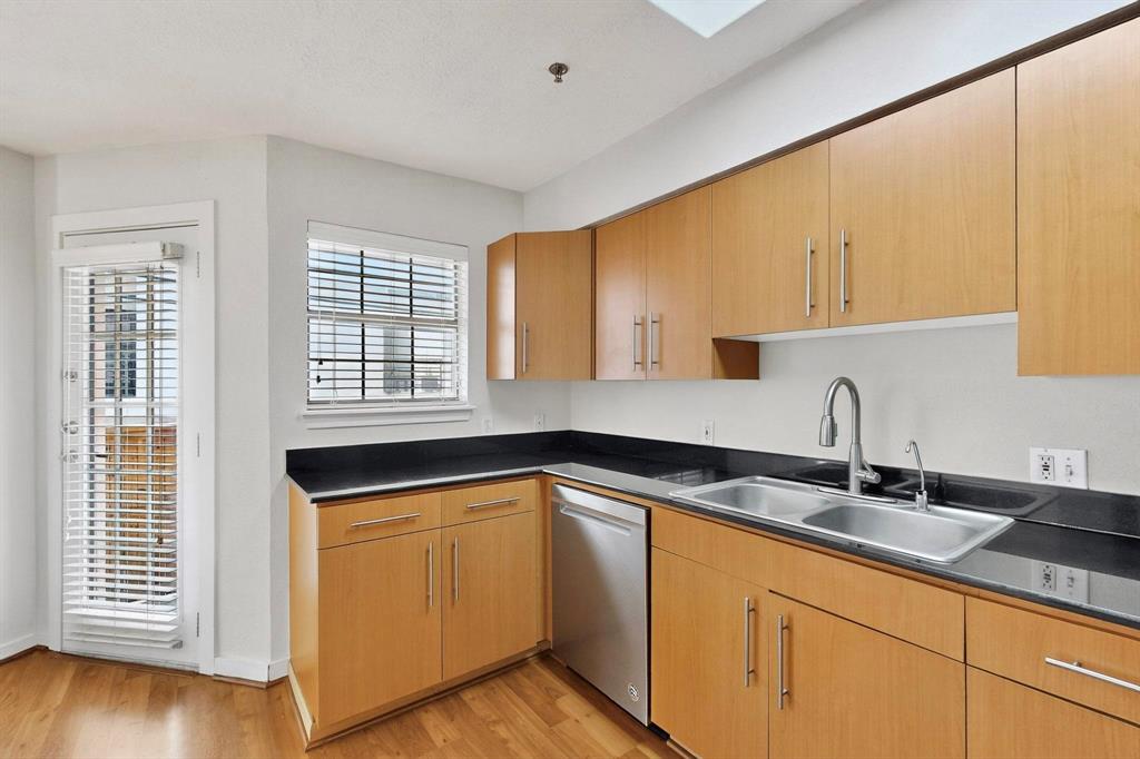 3901 Travis Street, Unit 113 Dallas, TX 75204 - Photo 4 of 40 a kitchen with granite countertop a sink and cabinets