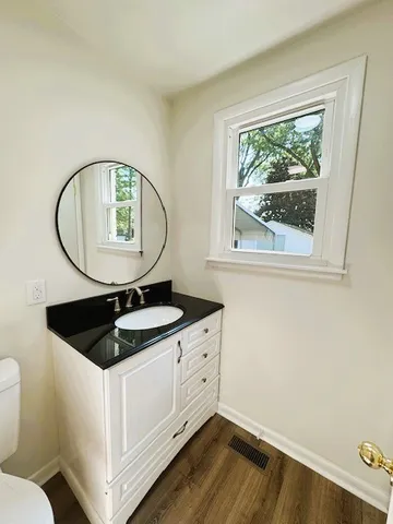 a view of a house with backyard and trees