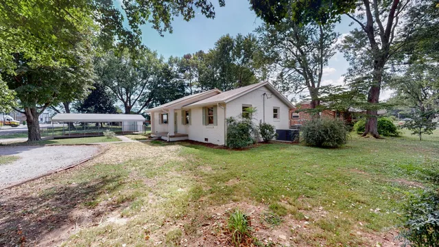 an aerial view of house with yard and outdoor seating